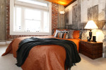 Dormitorio industrial con pared de ladrillo visto